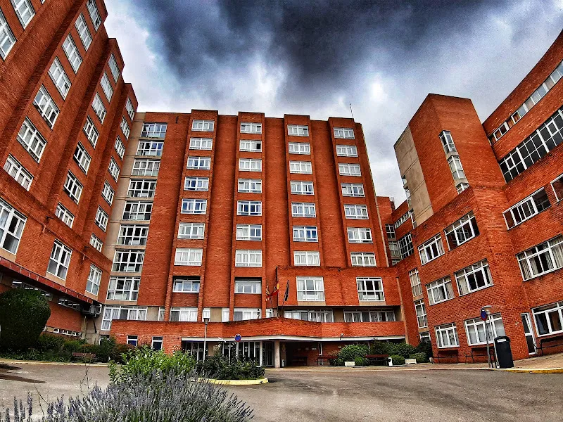 Iass residencia javalambre: fachada del centro asistencial de ladrillo rojo con entrada principal, banderas y ventanas en varios pisos