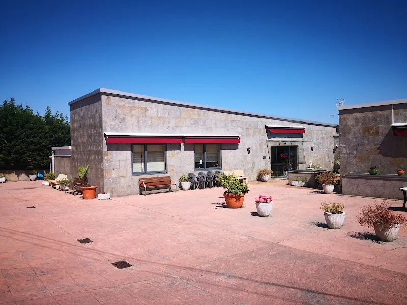 Edificio de una planta con patio amplio y macetas en la residencia tercera edad las salinas