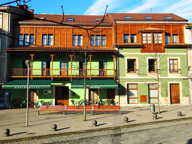 Fachada verde con balcones de madera y terraza exterior del residencial geriatrico santa cecilia